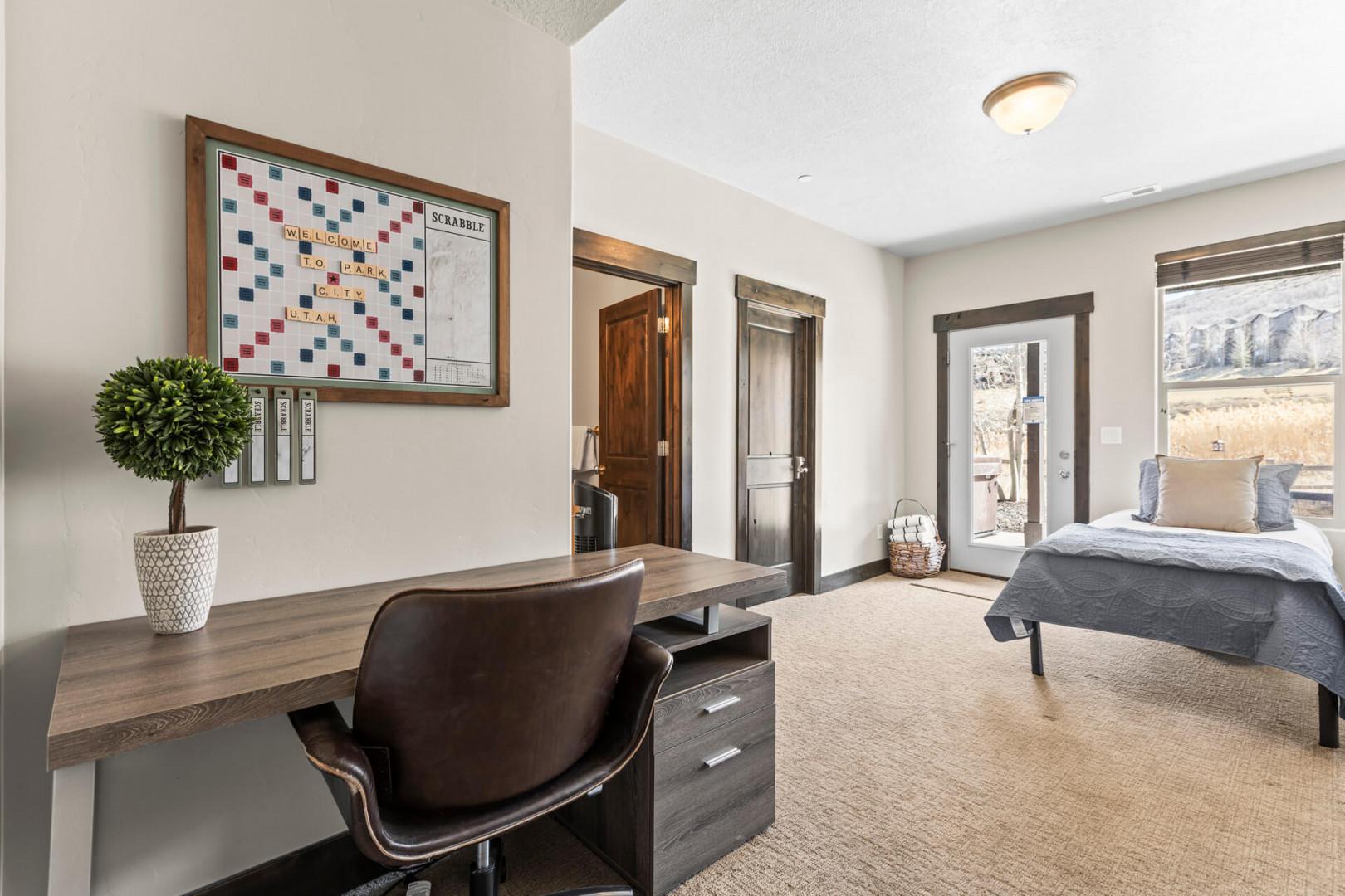 Your spacious bedroom combines comfort with productivity, featuring a dedicated workspace and mountain views through sliding doors to your private balcony.