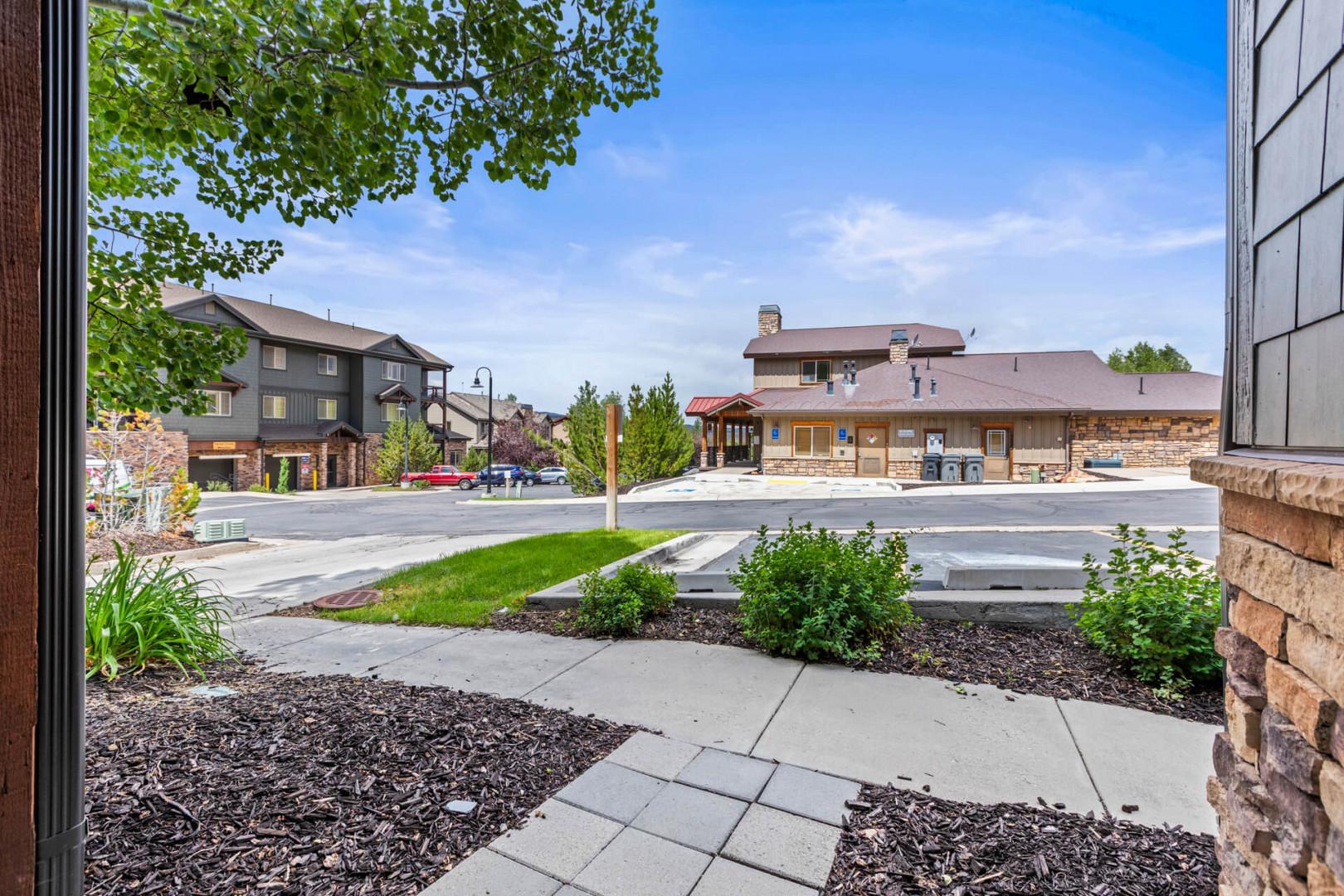 A peaceful neighborhood street with well-maintained landscaping and charming residential buildings just steps away from your vacation rental.