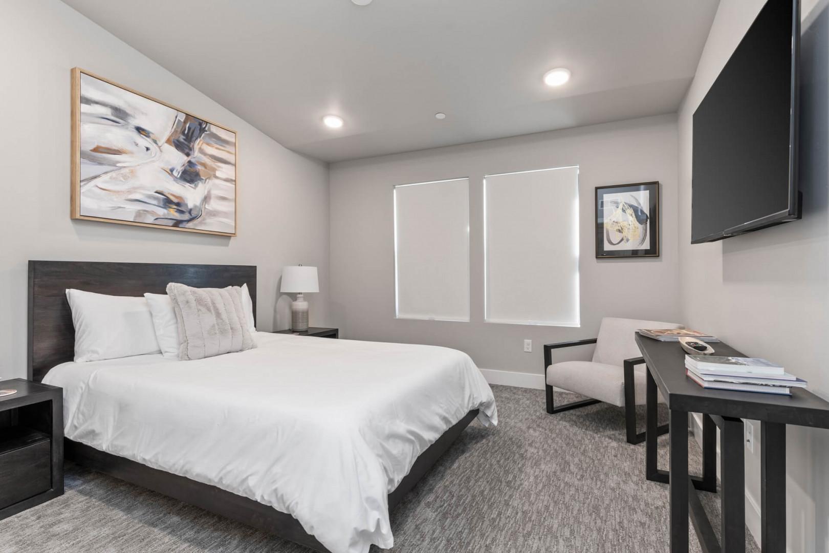 Mayflower Lakeside 301-45: "Sunlight streams through windows, illuminating the inviting bed and sofa chairs."