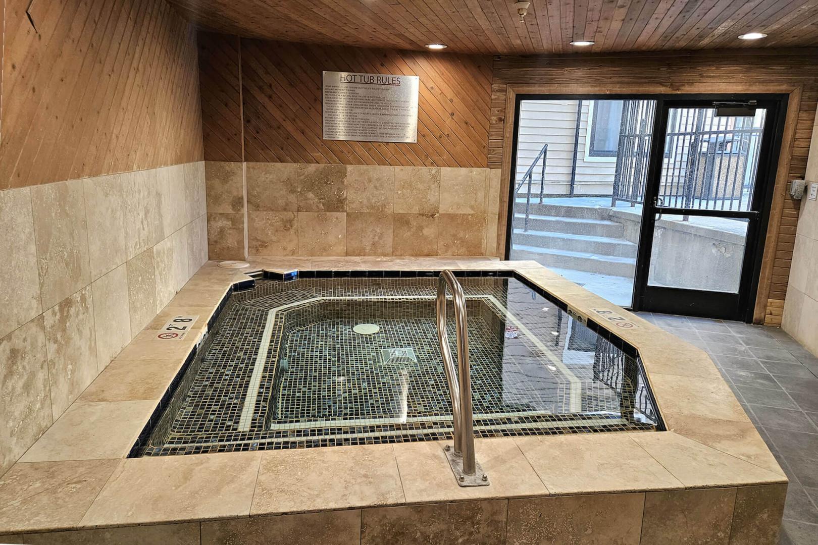 The property features an indoor hot tub with easy access steps and handrails, available for your relaxation throughout your stay.