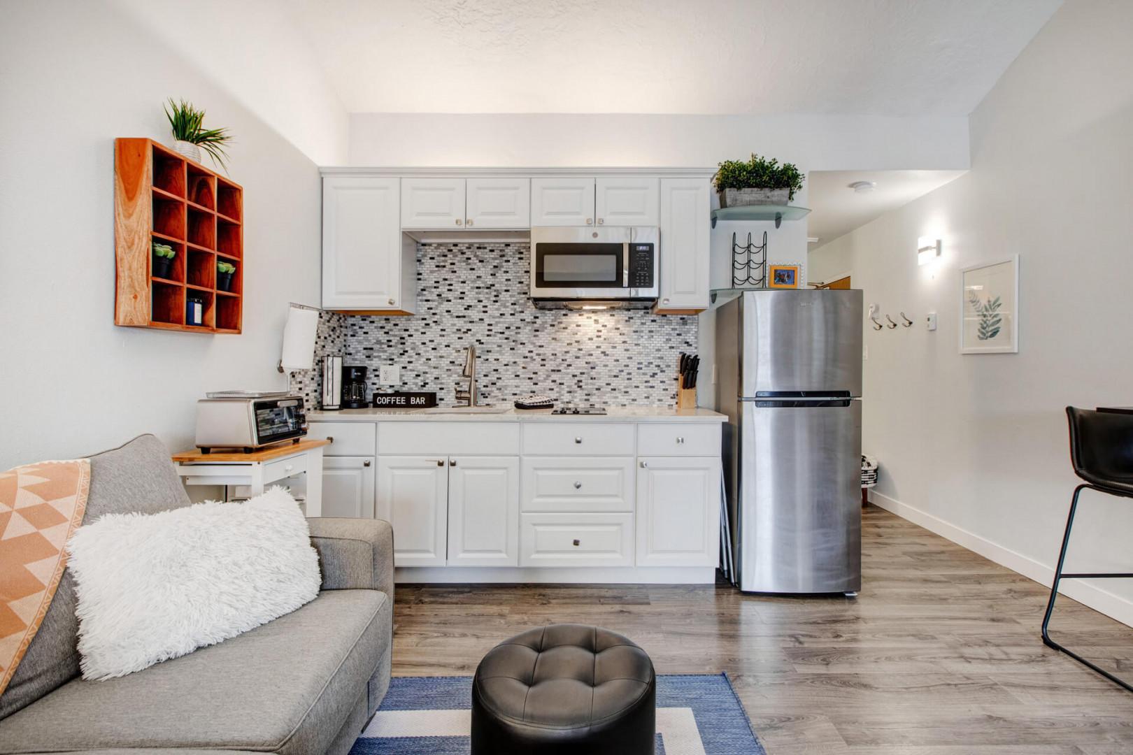 Your stylish open-plan retreat combines a fully equipped kitchen with cozy living space, perfect for cooking and relaxing.