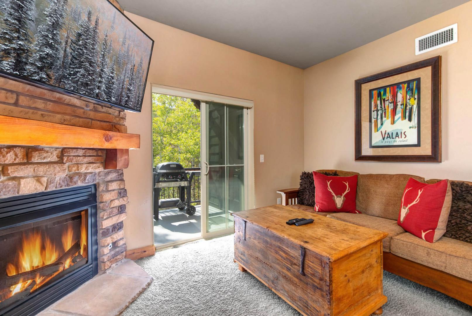 Settle into your cozy living room, where a crackling fireplace and mountain-inspired touches invite you to unwind. Step outside to your private balcony and savor peaceful moments in the fresh air.
