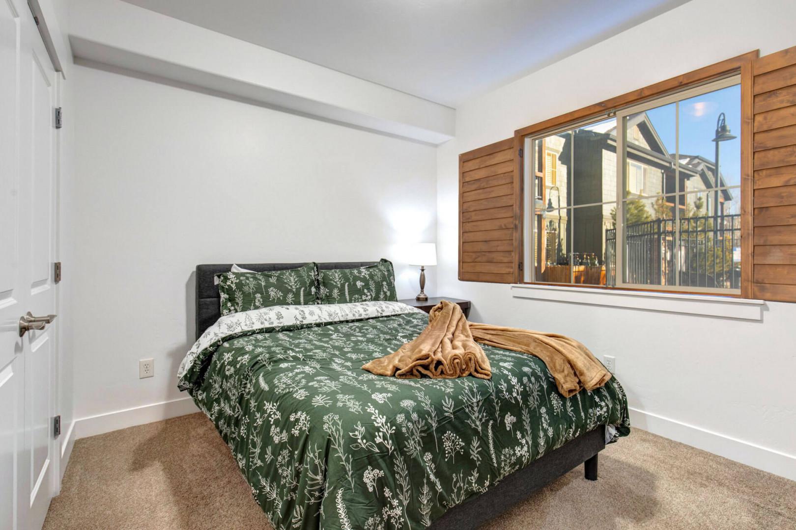 Drift off to sleep in your peaceful bedroom with botanical bedding and warm natural light streaming through the shutters.