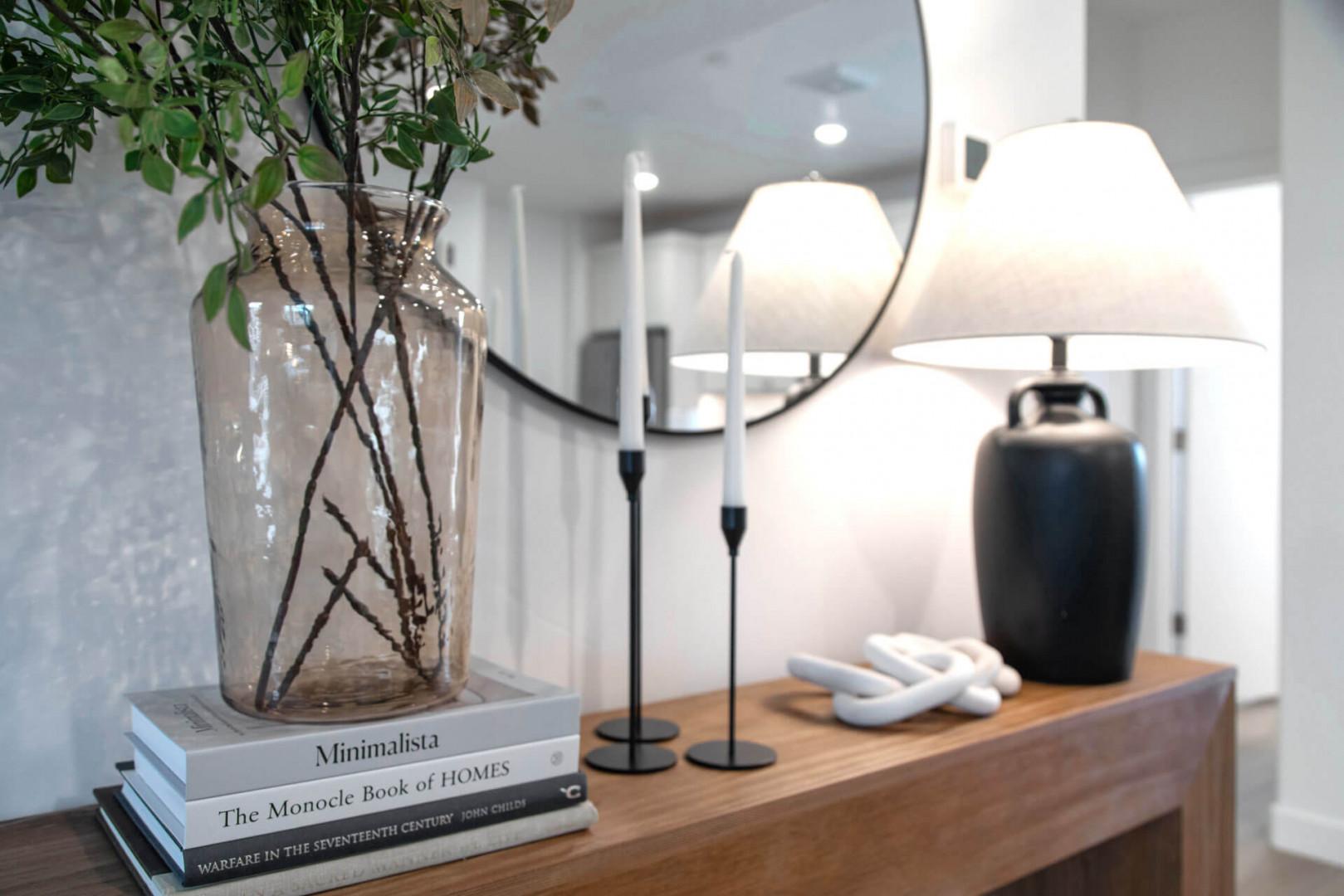 You'll love the thoughtful details on your stylish console—elegant lamps, curated books, and natural greenery create a warm, sophisticated atmosphere.