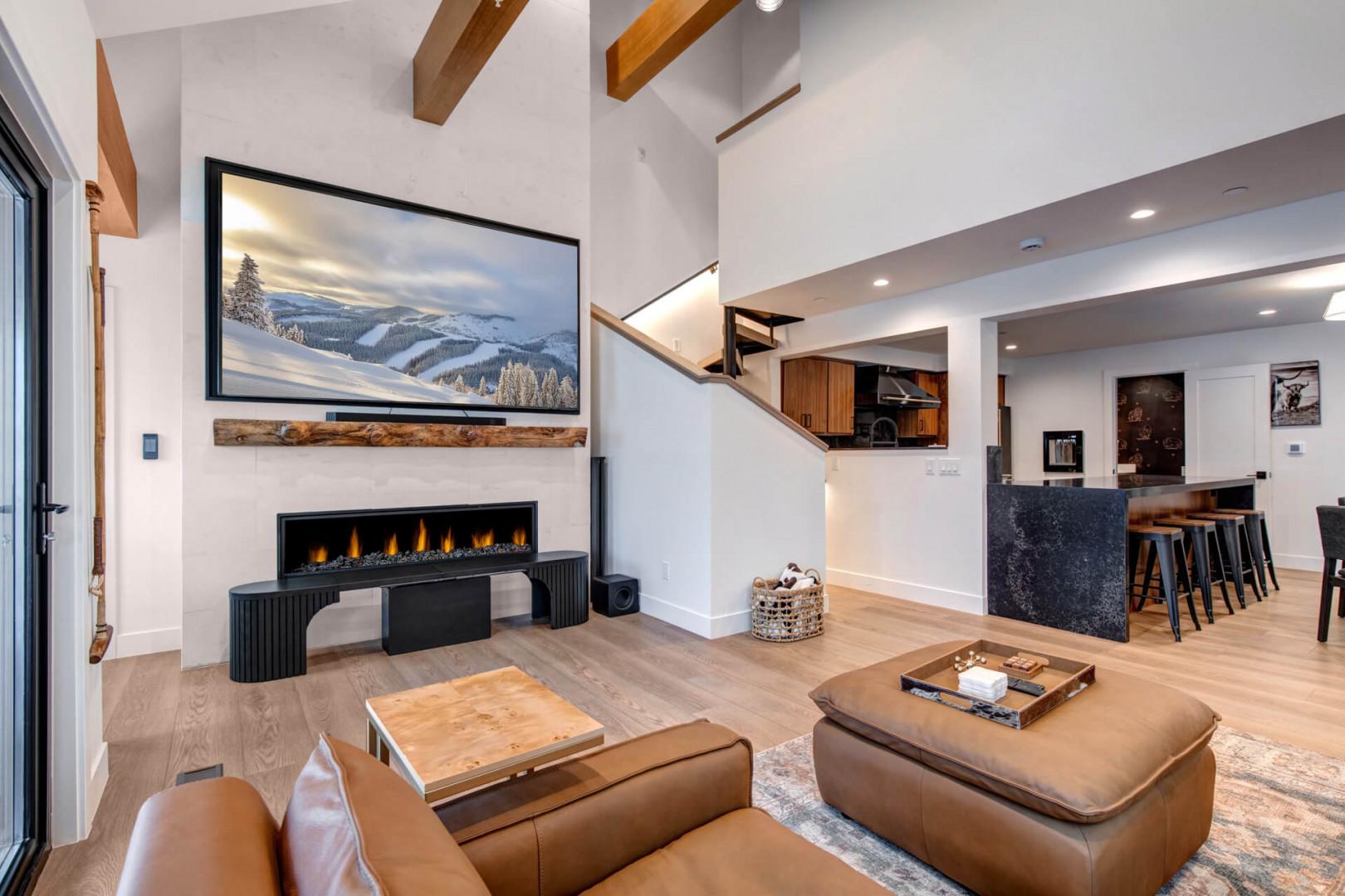 Upper Main 301: Relax in this stunning open-concept living space with soaring ceilings, exposed beams, and a cozy fireplace perfect for mountain evenings.