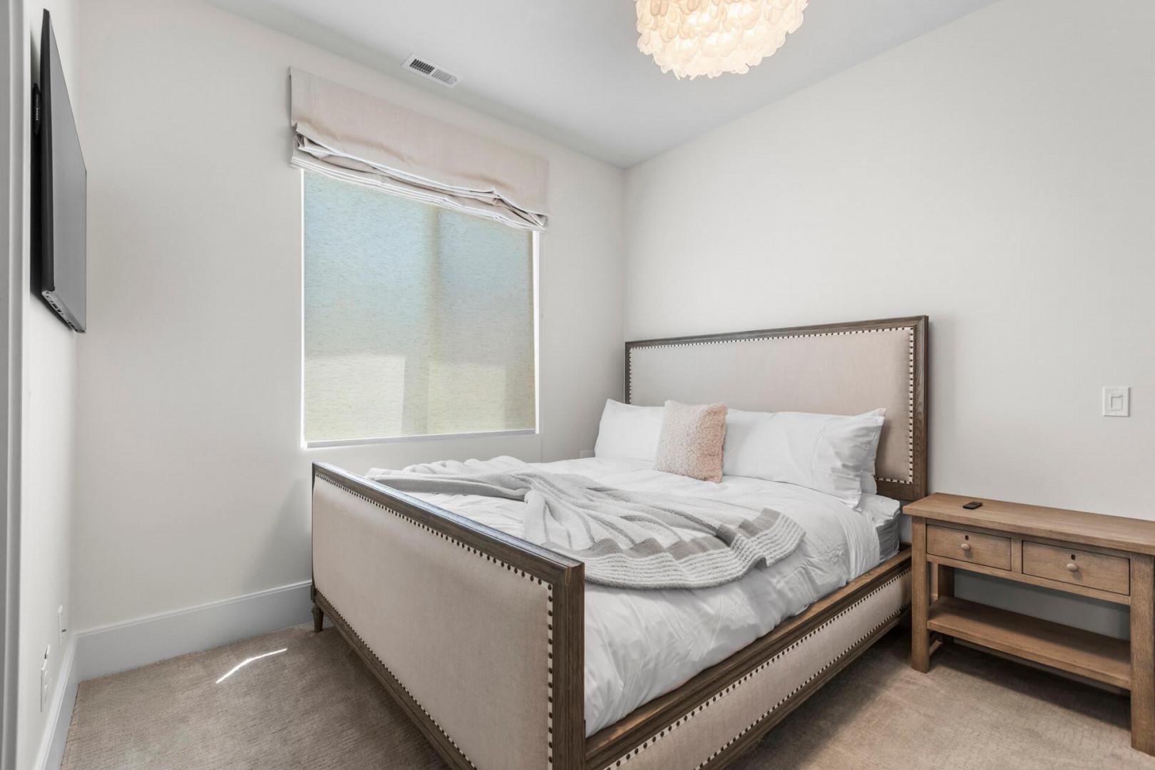 Unwind in your serene bedroom featuring plush bedding, soft natural light, and a statement chandelier to help you drift into peaceful sleep.