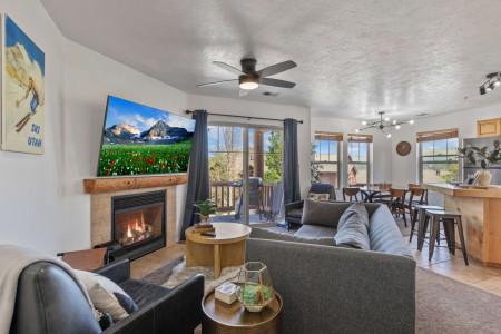 Cozy sofa, fireplace and TV with large window view