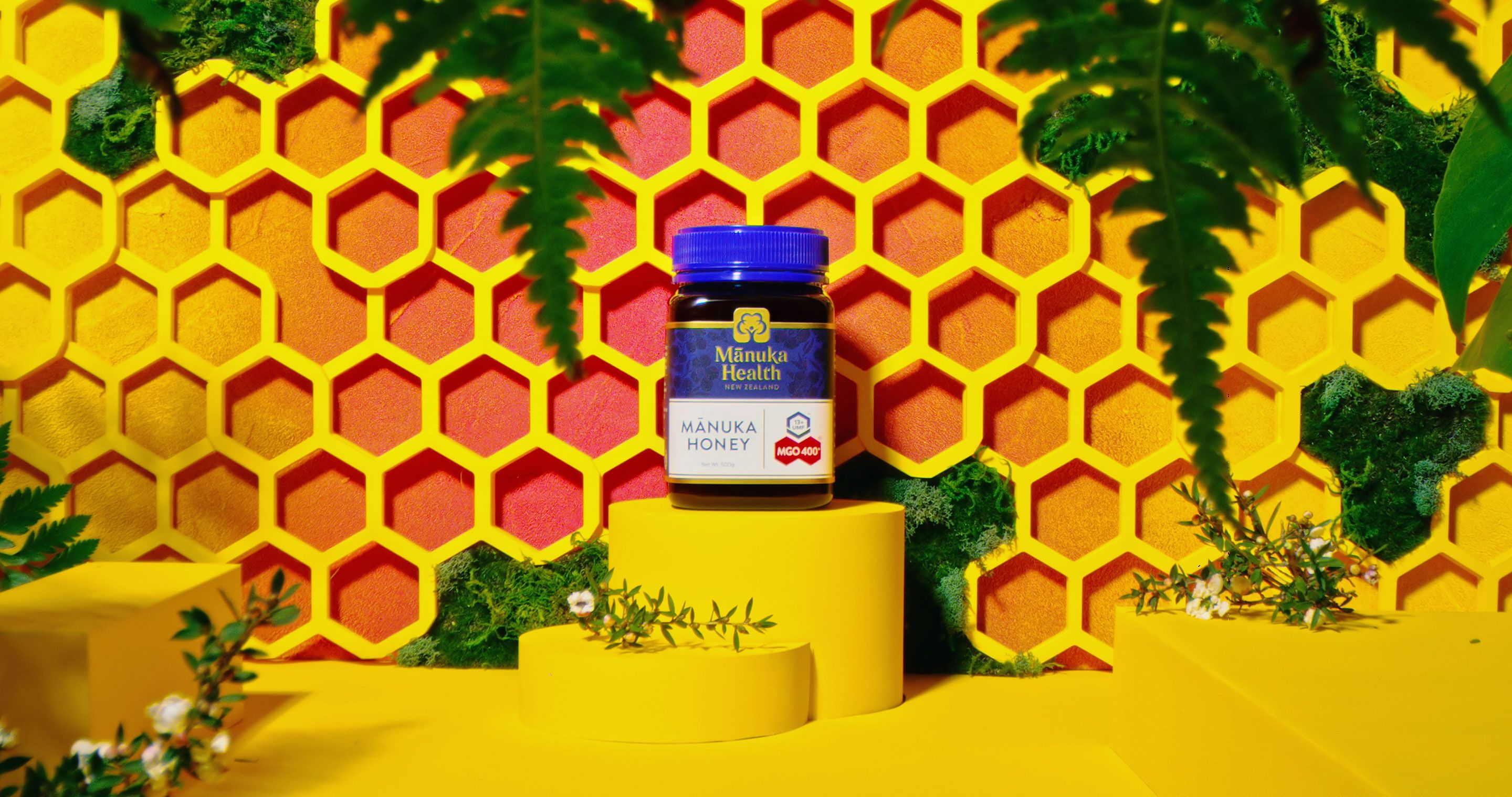 Jar of Manuka Health honey staged in front of a honeycomb-inspired backdrop