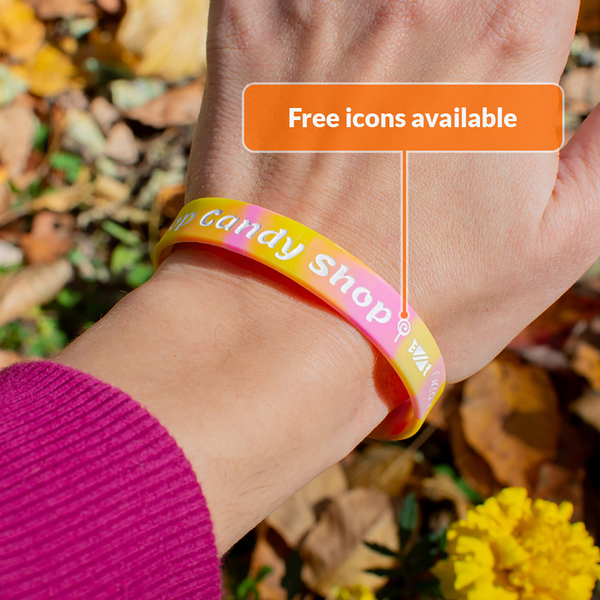 closeup of wrist wearing a candy shop silicone wristband with a lollipop icon