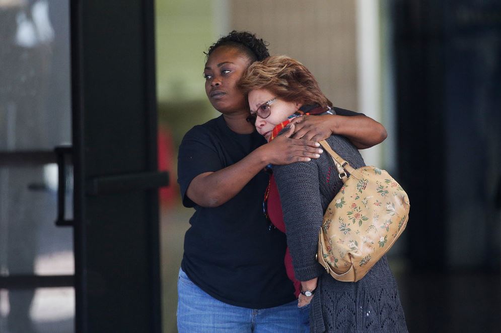 Two women embrace at a community center where family members have been gathering to pick up survivors after the shooting rampage at a social services center in San Bernardino, Calif. (AP/Jae C. Hong)