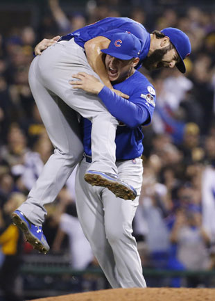 Chicago Cubs first baseman Anthony Rizzo hoists starting pitcher Jake Arrieta aloft after he finished a complete-game shutout of the Pittsburgh Pirates in the National League wild card game Wednesday in Pittsburgh. Arrieta struck out 11 while giving up four hits and no walks. (Gene J. Puskar/AP)