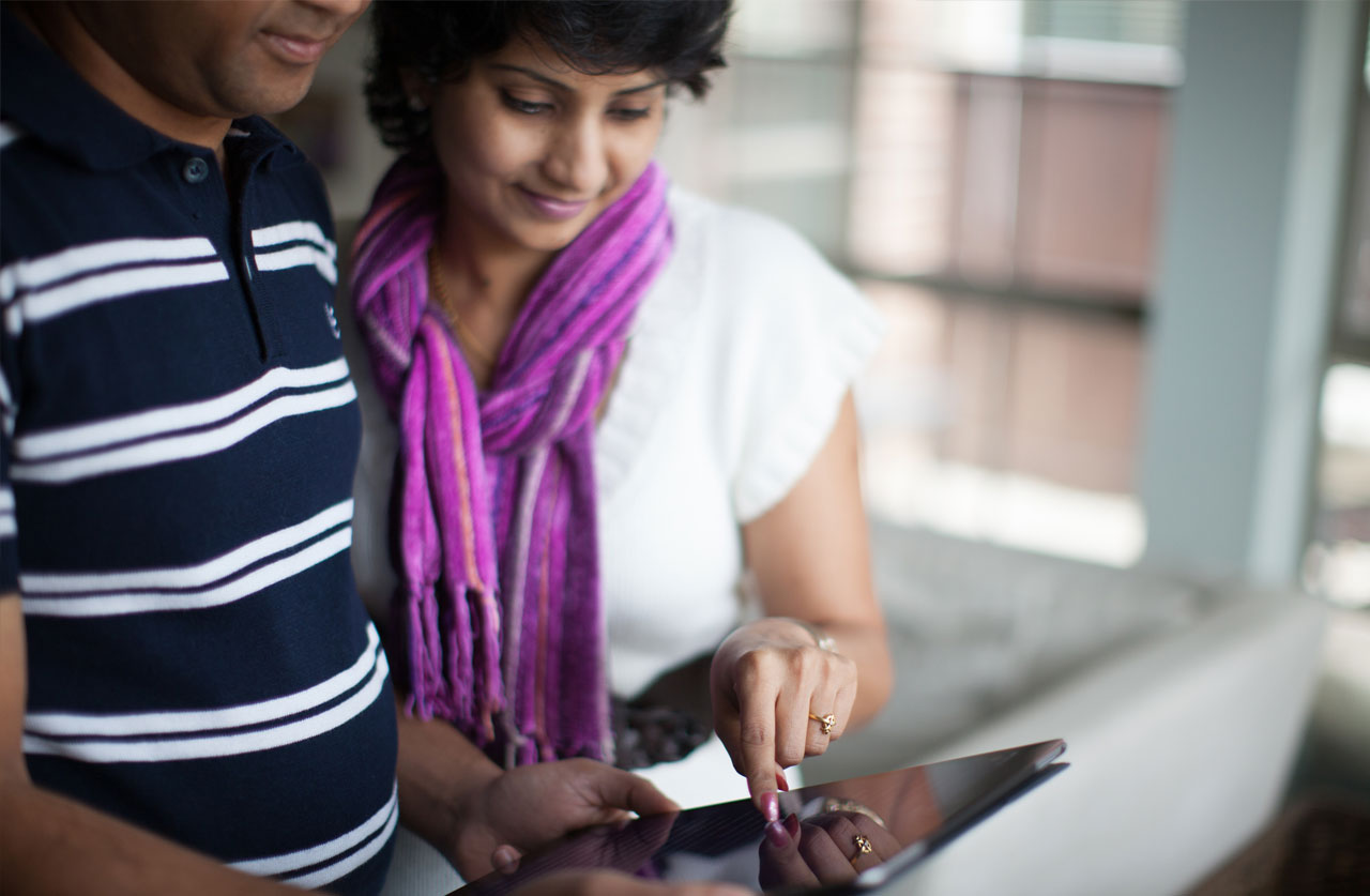 Couple reading Bible on tablet