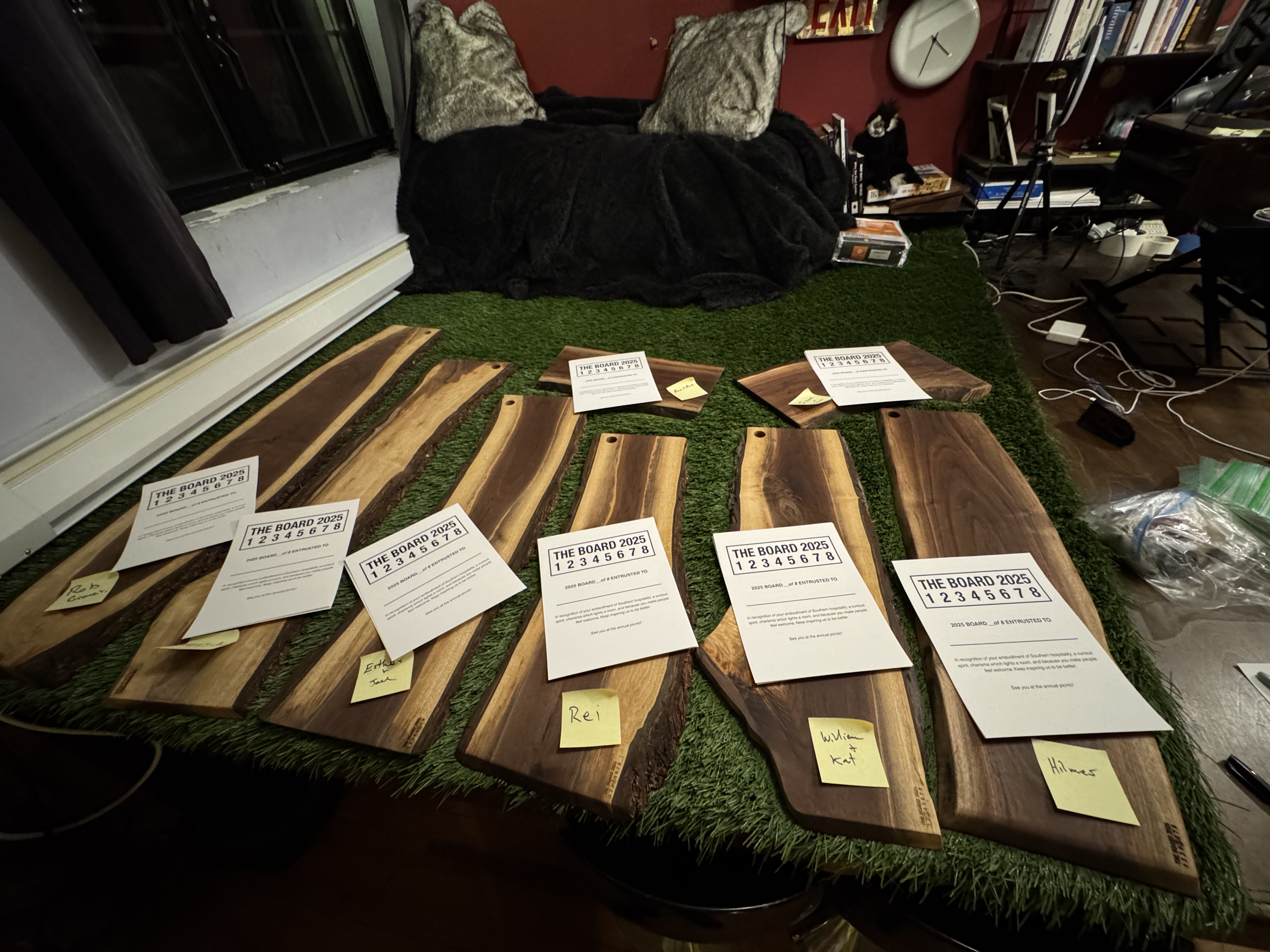All eight 2025 boards laid out with invitation cards