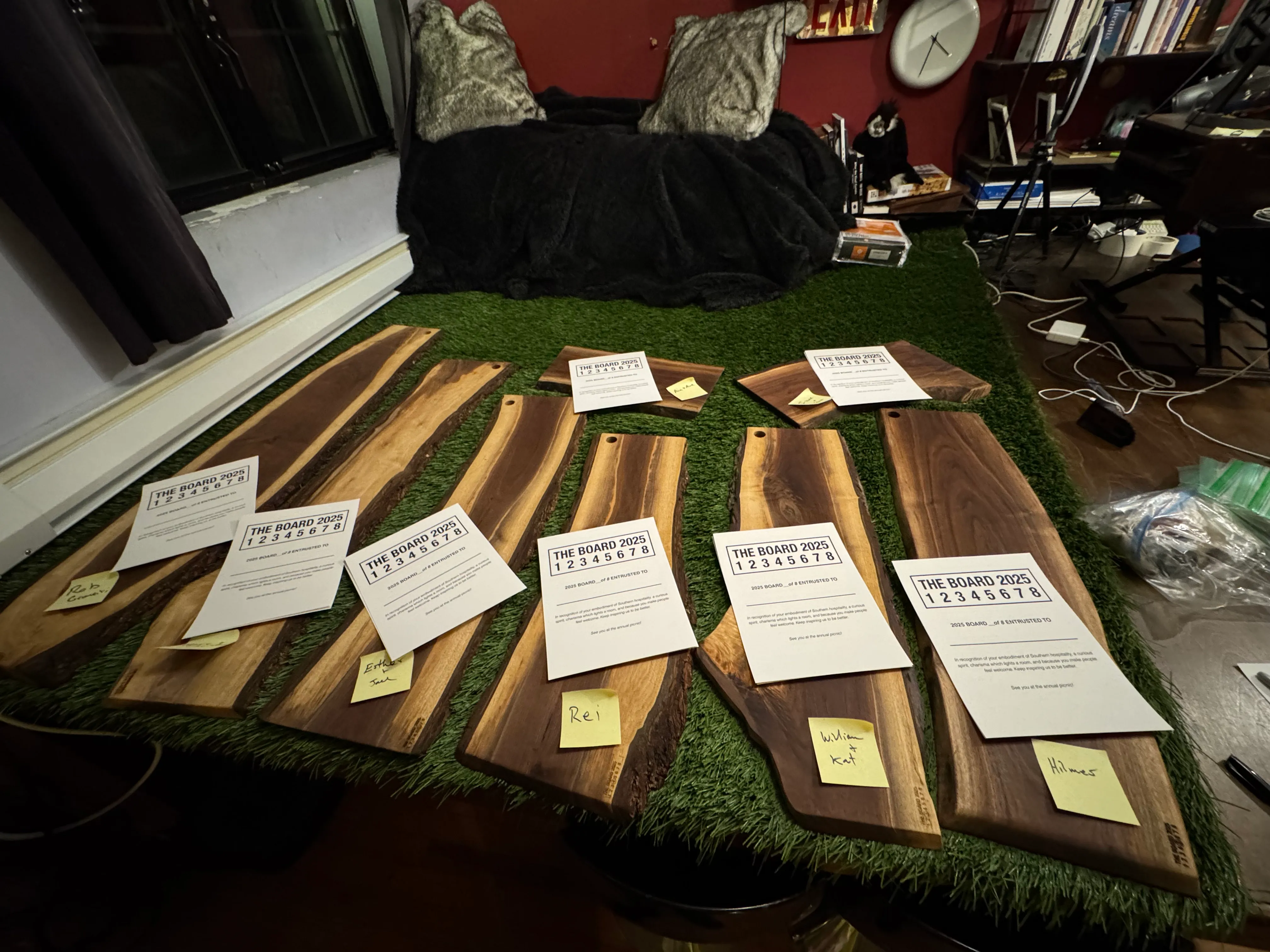 All eight 2025 boards laid out with invitation cards