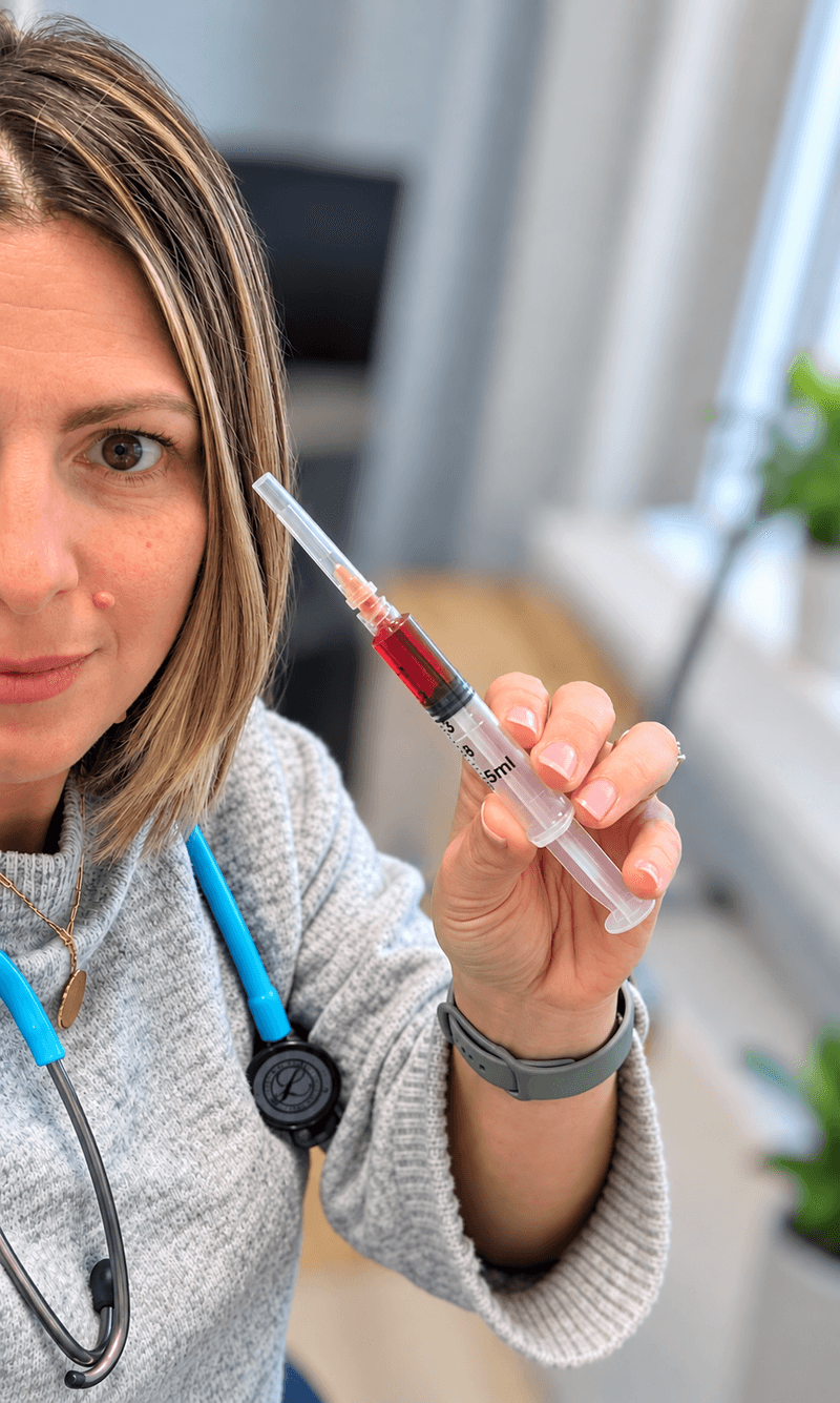 MedCAiRE nurse holding a syringe of vitamin B12