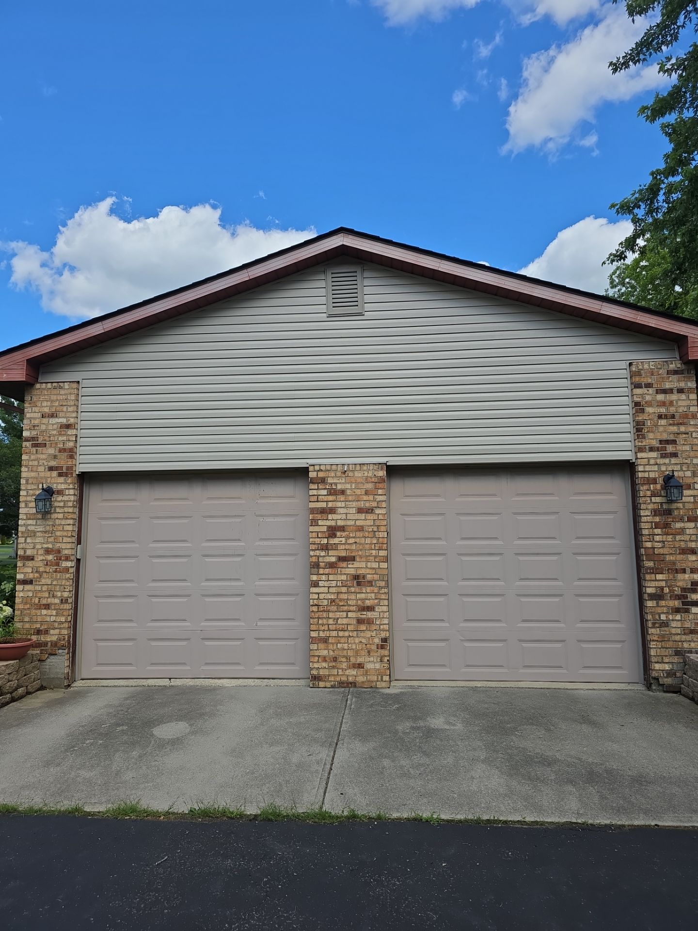 Garage doors and repaired siding after storm restoration on a Dublin, Ohio property