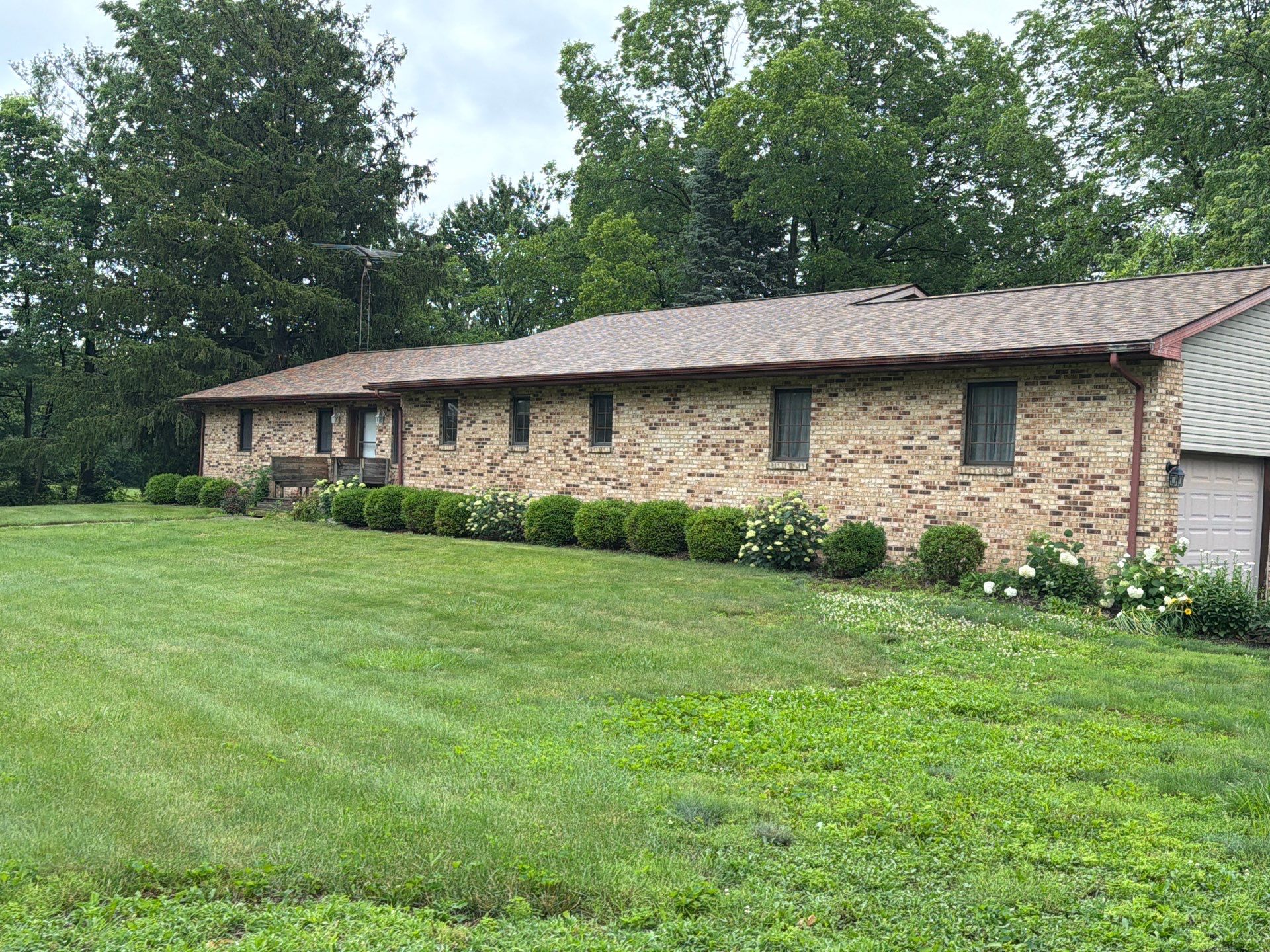 Long side of the Dublin property after storm restoration by 614 Exteriors, with repaired siding and new gutters