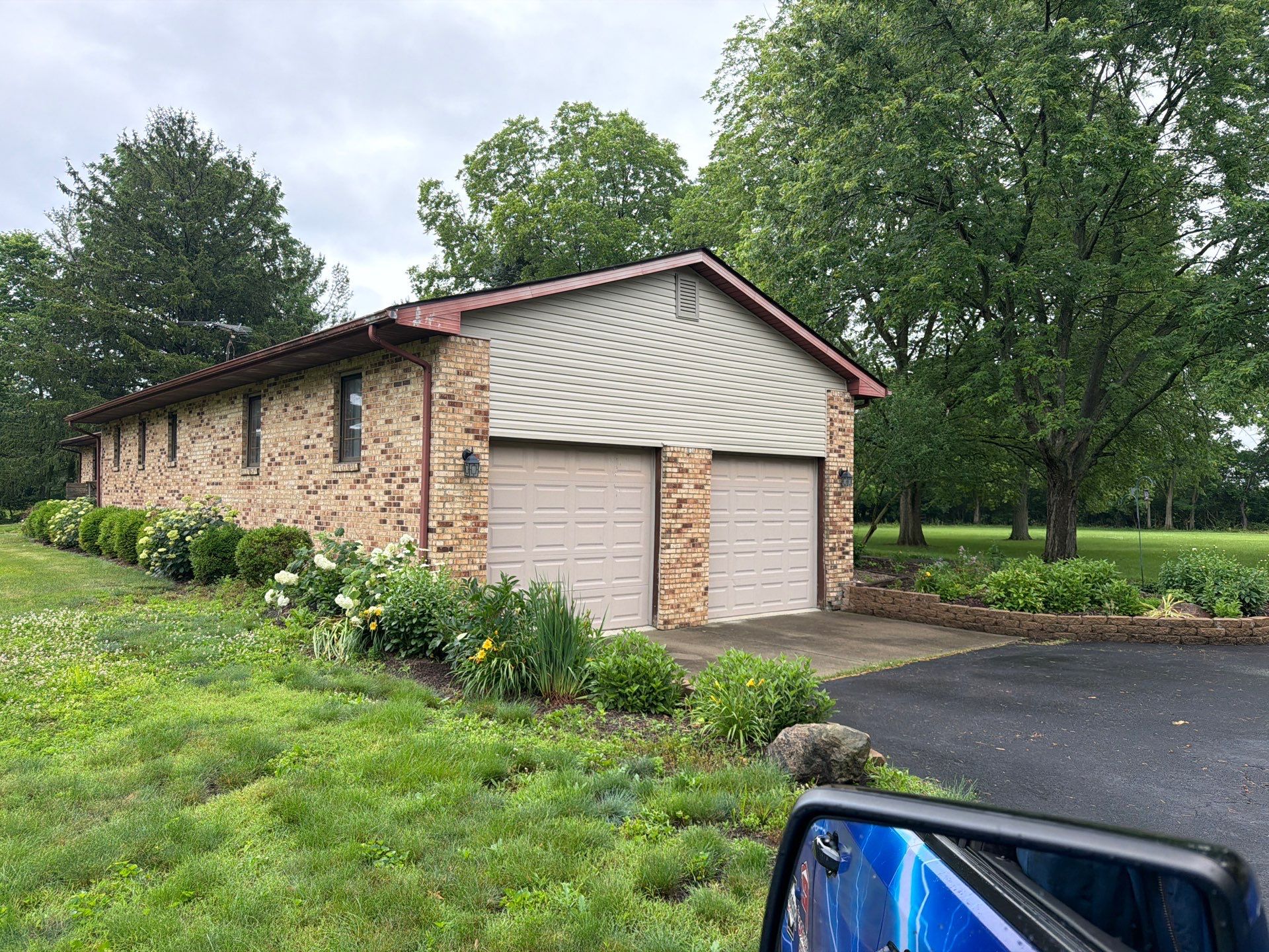 Side of the building after siding repair and gutter replacement