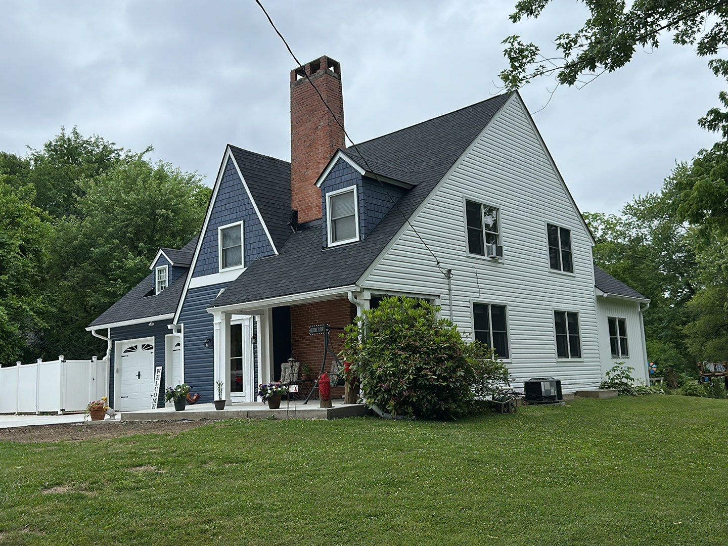 Finished dark blue siding from front side angle