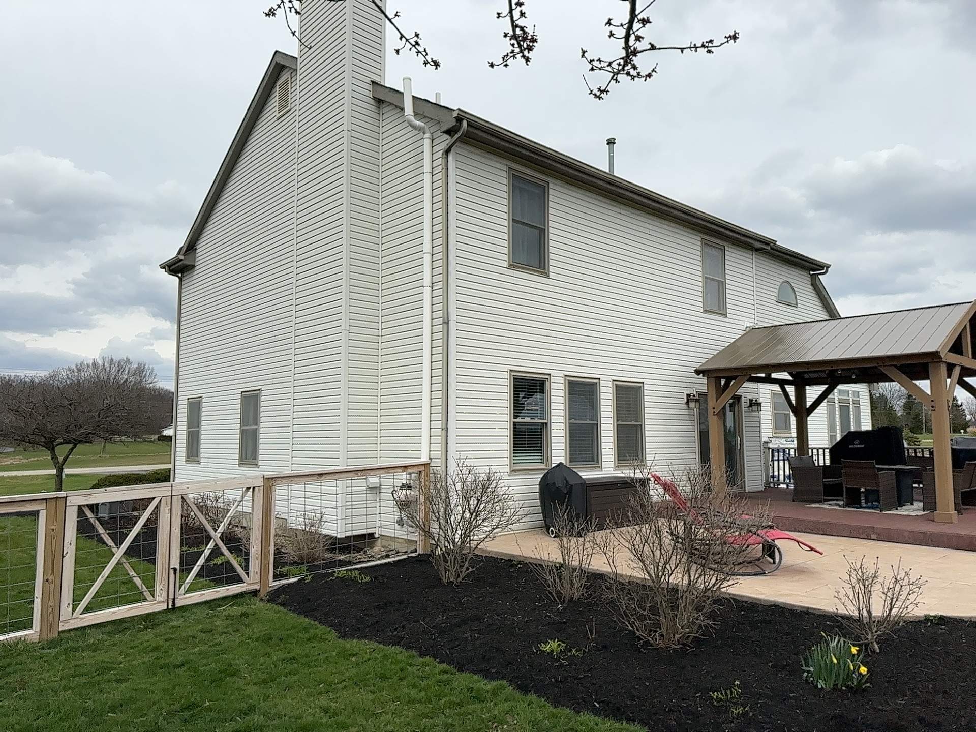 Side of the home before renovation, showing the original light siding