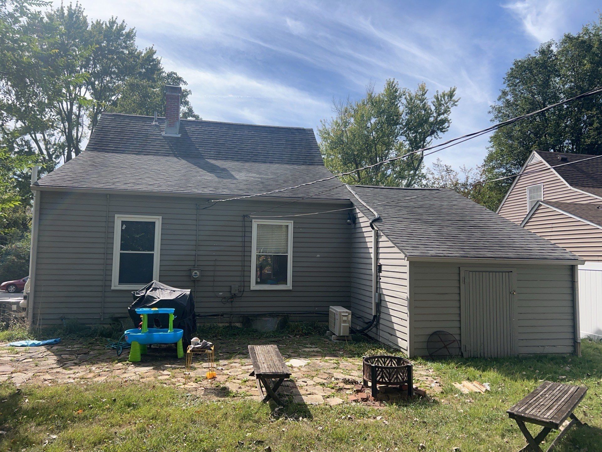 Rear of the home before restoration, with the original siding and roof