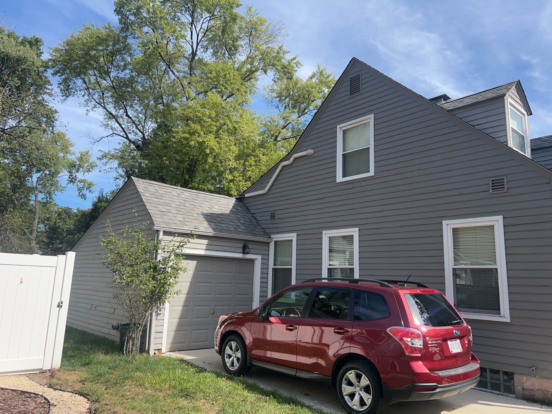 Driveway side of the home and garage area before roof and siding replacement