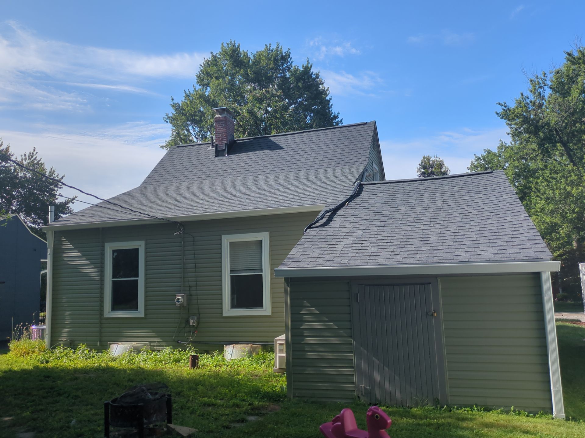 Rear of the home after the new roof and siding were installed