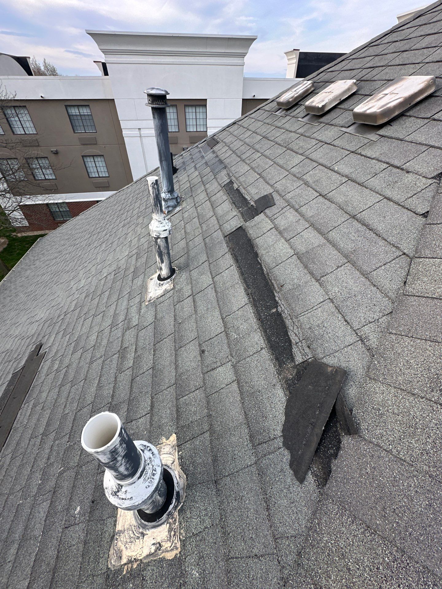 Close-up of damaged asphalt shingles on the Ohio Heart Group roof before replacement