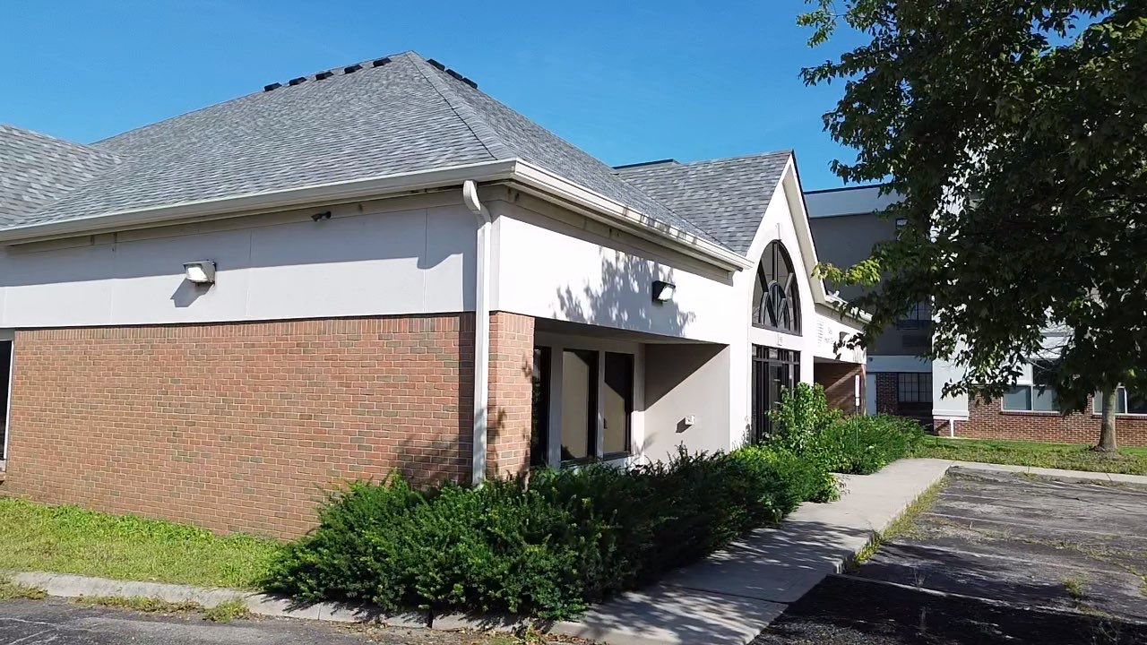 Side of the Ohio Heart Group brick building with its new gray asphalt shingle roof