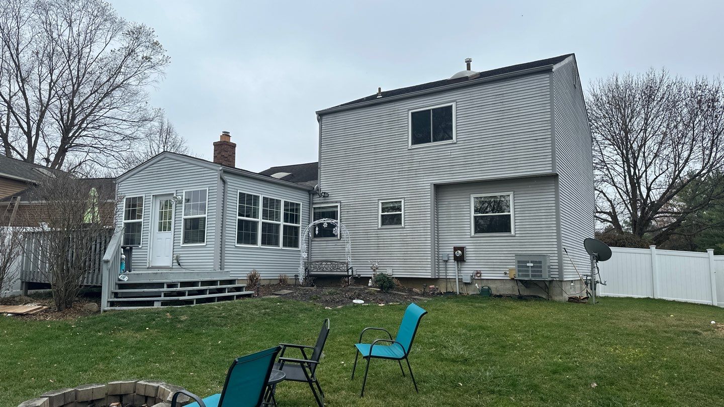 Rear of the home before the exterior renovation, showing light siding