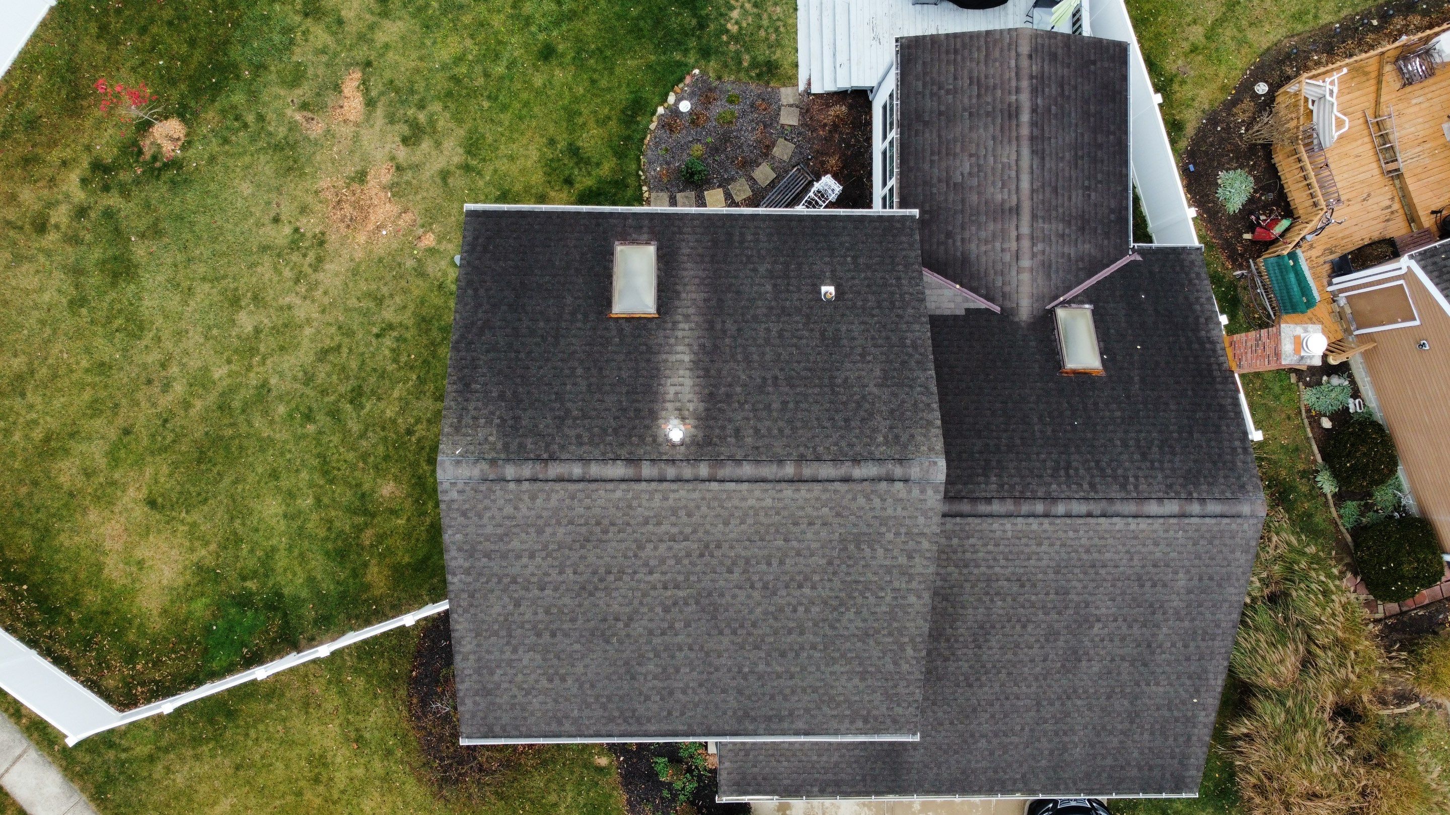 Aerial view of the home's older dark roof before roof replacement