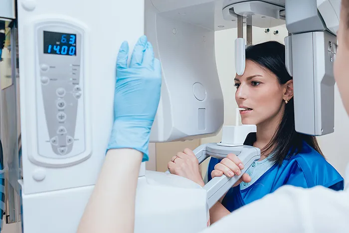 A patient positioned for a dental cone-beam imaging examination