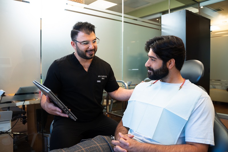 Dr. Raufy discussing a personalized dental treatment plan with a patient
