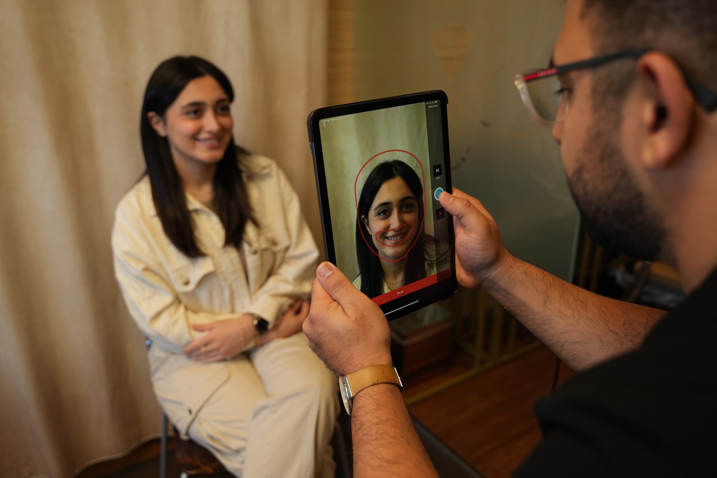Dr. Raufy discussing a patient's smile at Flawless Dental Studio