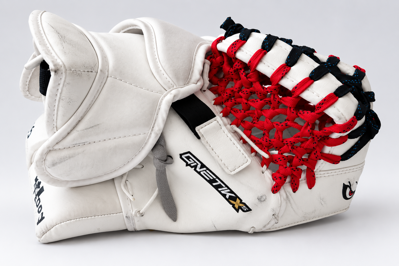Real white goalie catcher featuring custom red and black pocket lacing by Hockey Detox