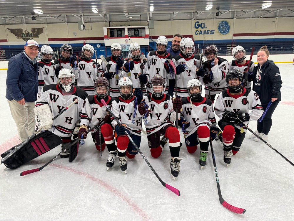 Winchester Youth Hockey girls and coaches together after a tournament win