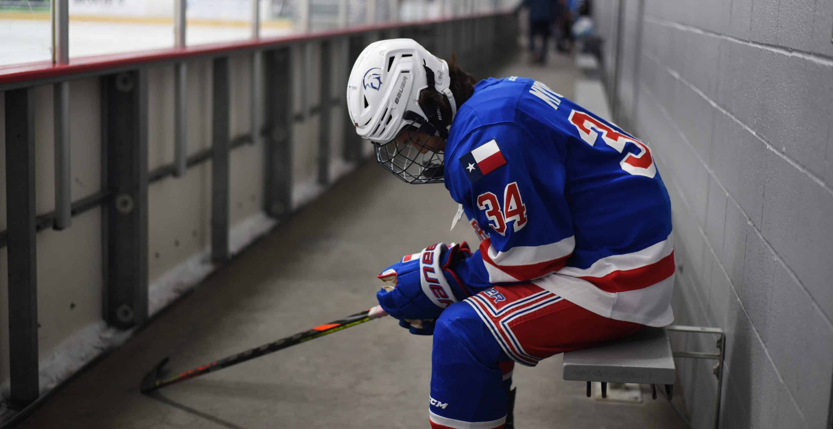 A hockey player alone on a bench with his head down, from Hockey Detox Journal 008