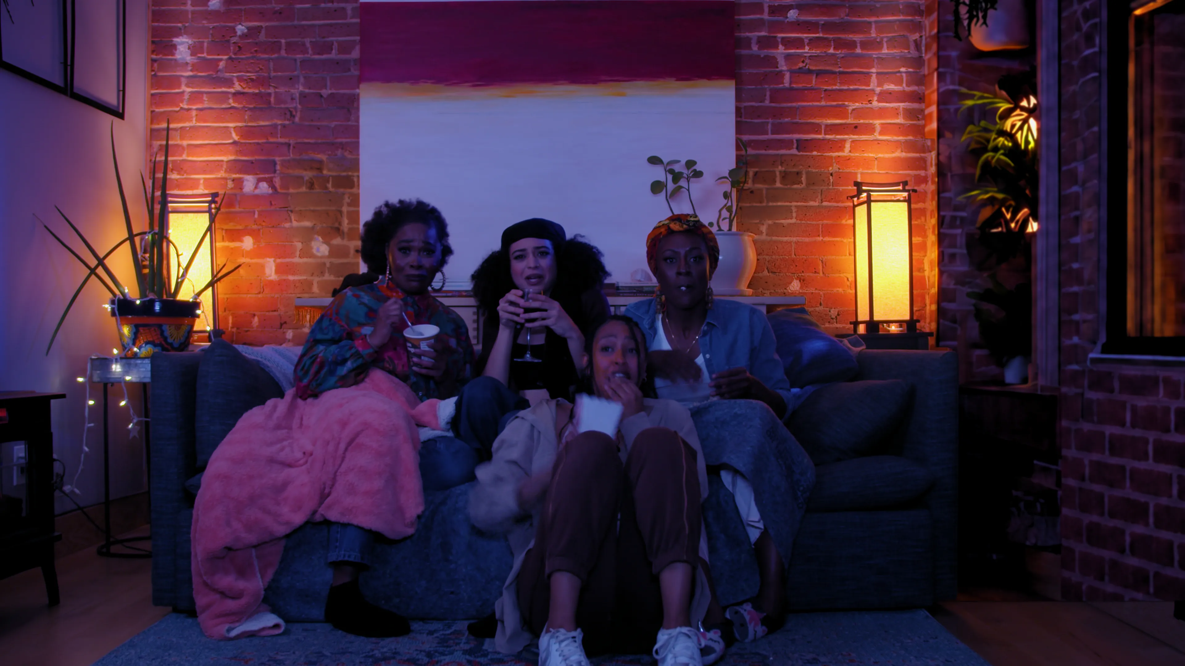 Four friends on the couch during True Laundry’s Girlfriends’ Messy Movie Night
