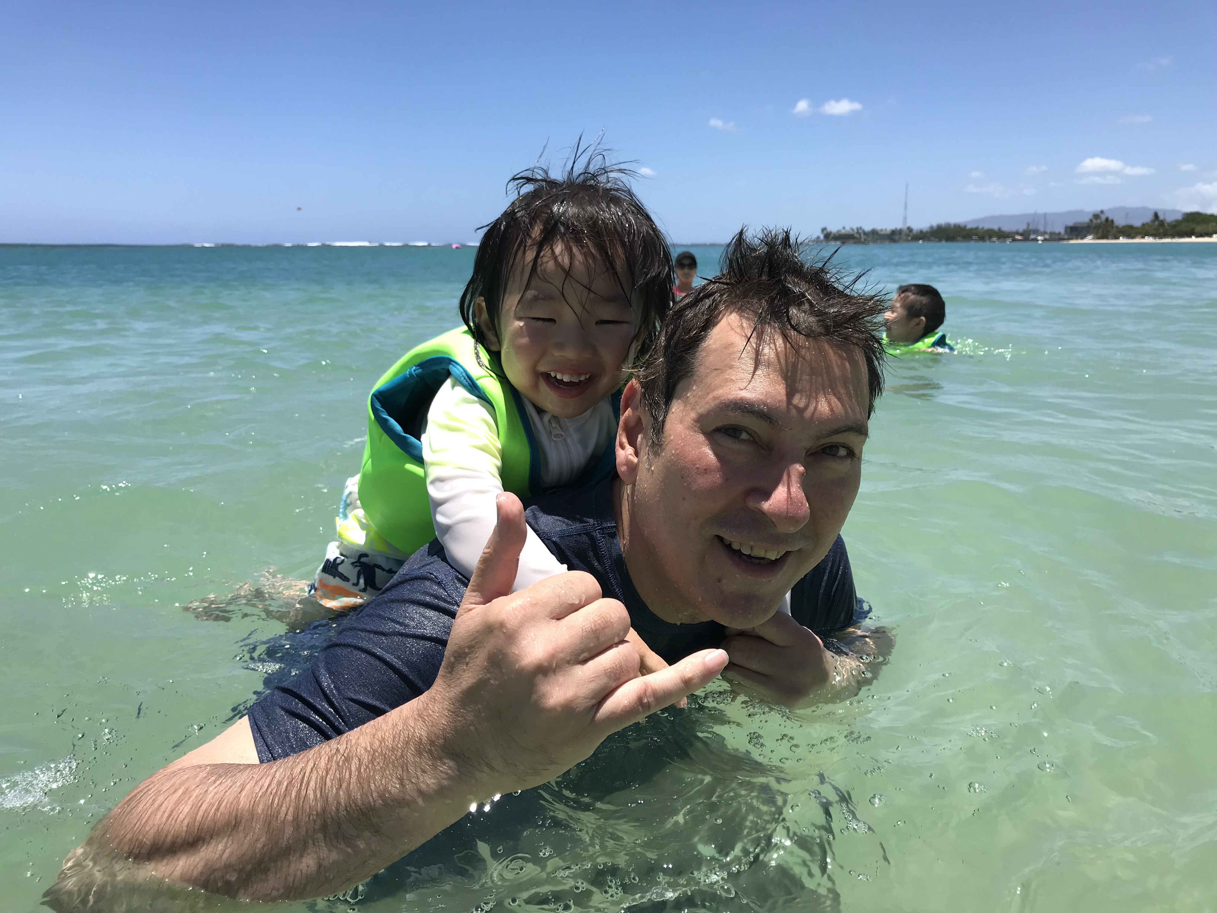 Jerry swimming with a small child in Hawaii