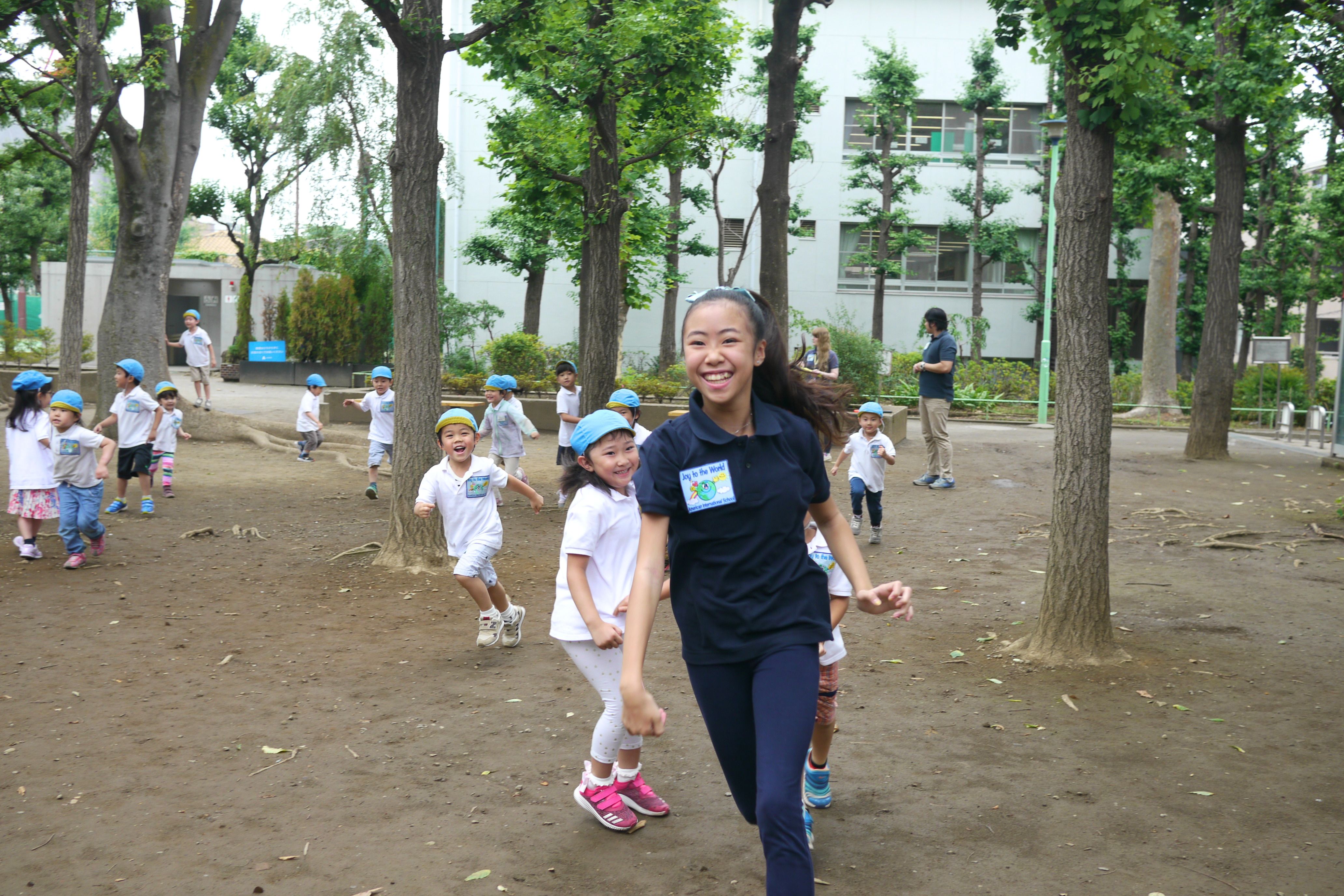 Former Joy student Nana volunteering with younger children
