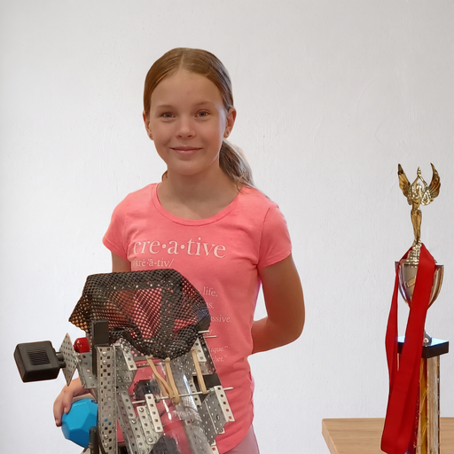 AcademyACL student with robotics trophies and her VEX robot