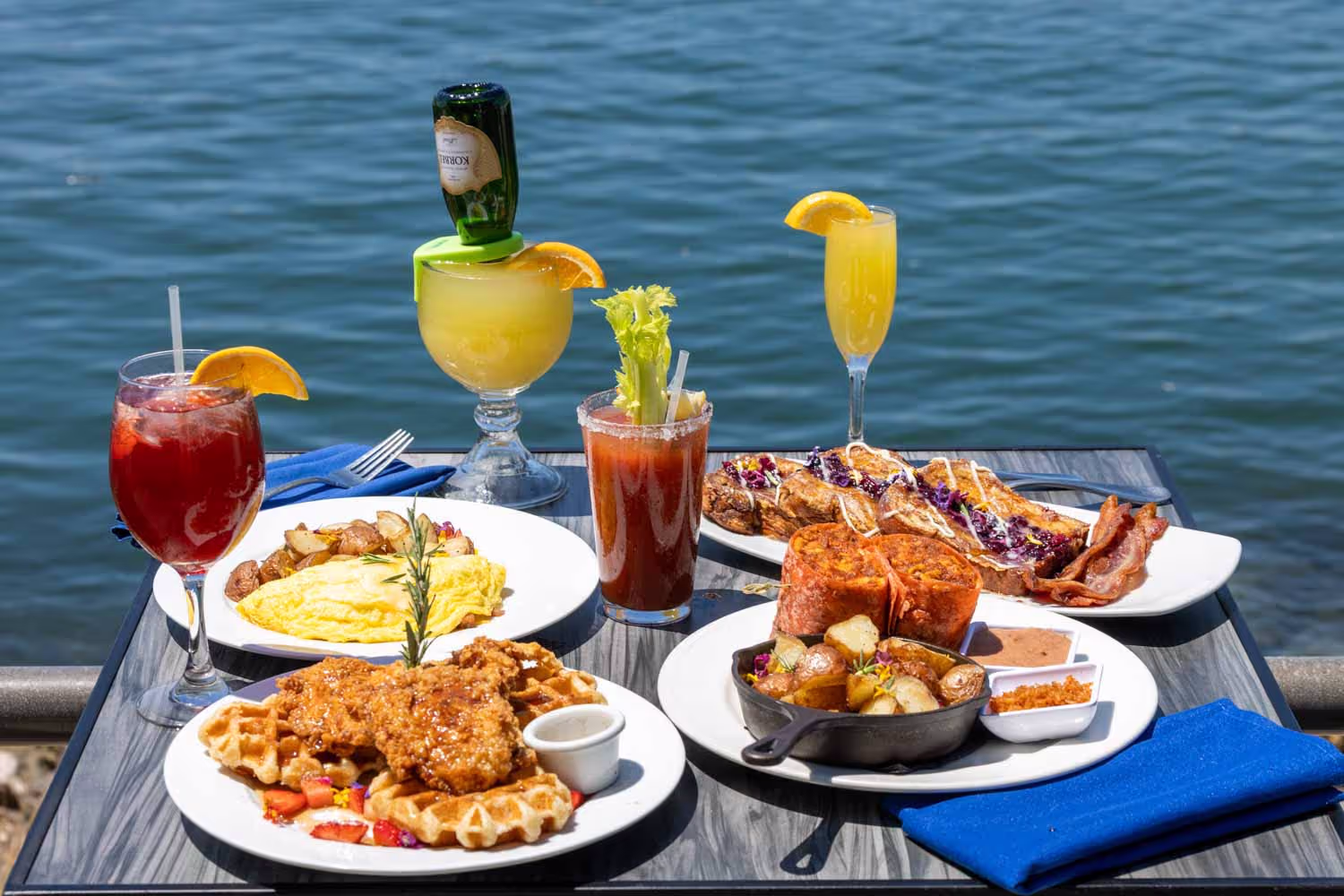 A weekend brunch food spread on a table at Boathouse on the Bay overlooking Alamitos Bay