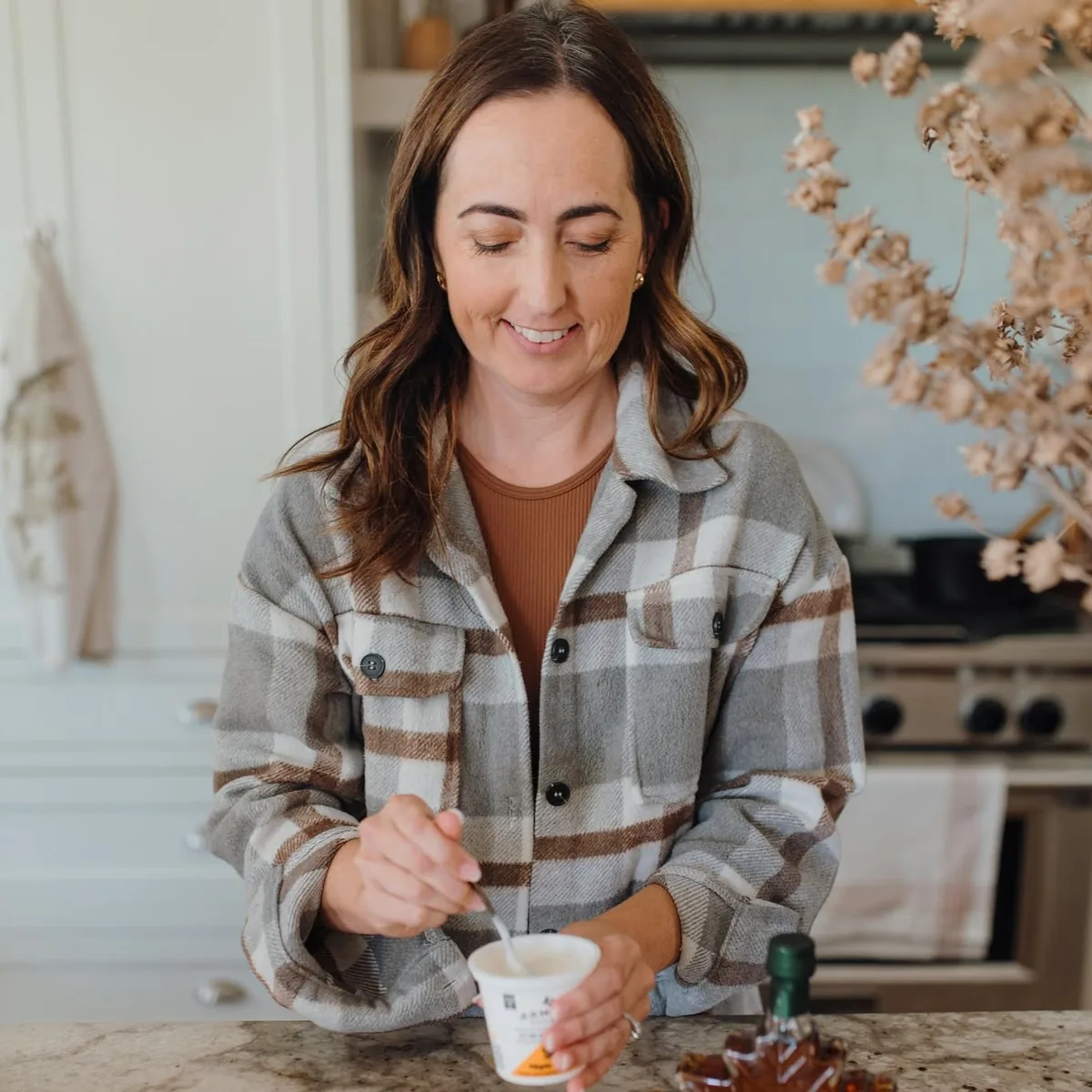 Katie McDowell in her kitchen, spooning Armagh Creamery yogurt