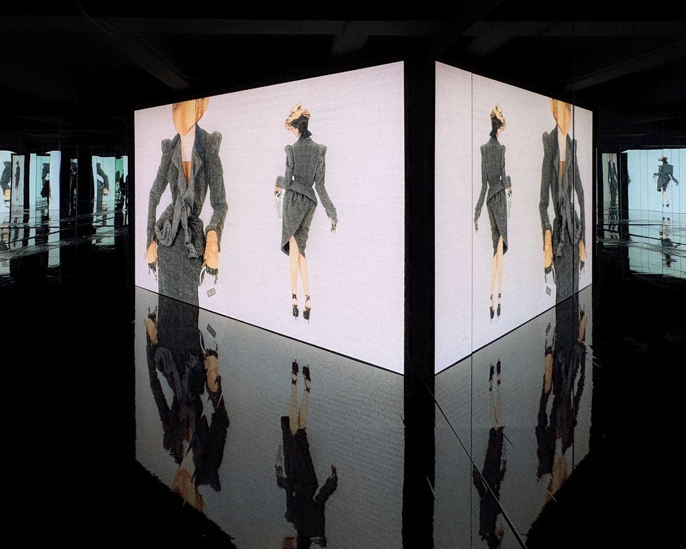 White screens and their reflections form a luminous volume within the Tokyo exhibition.