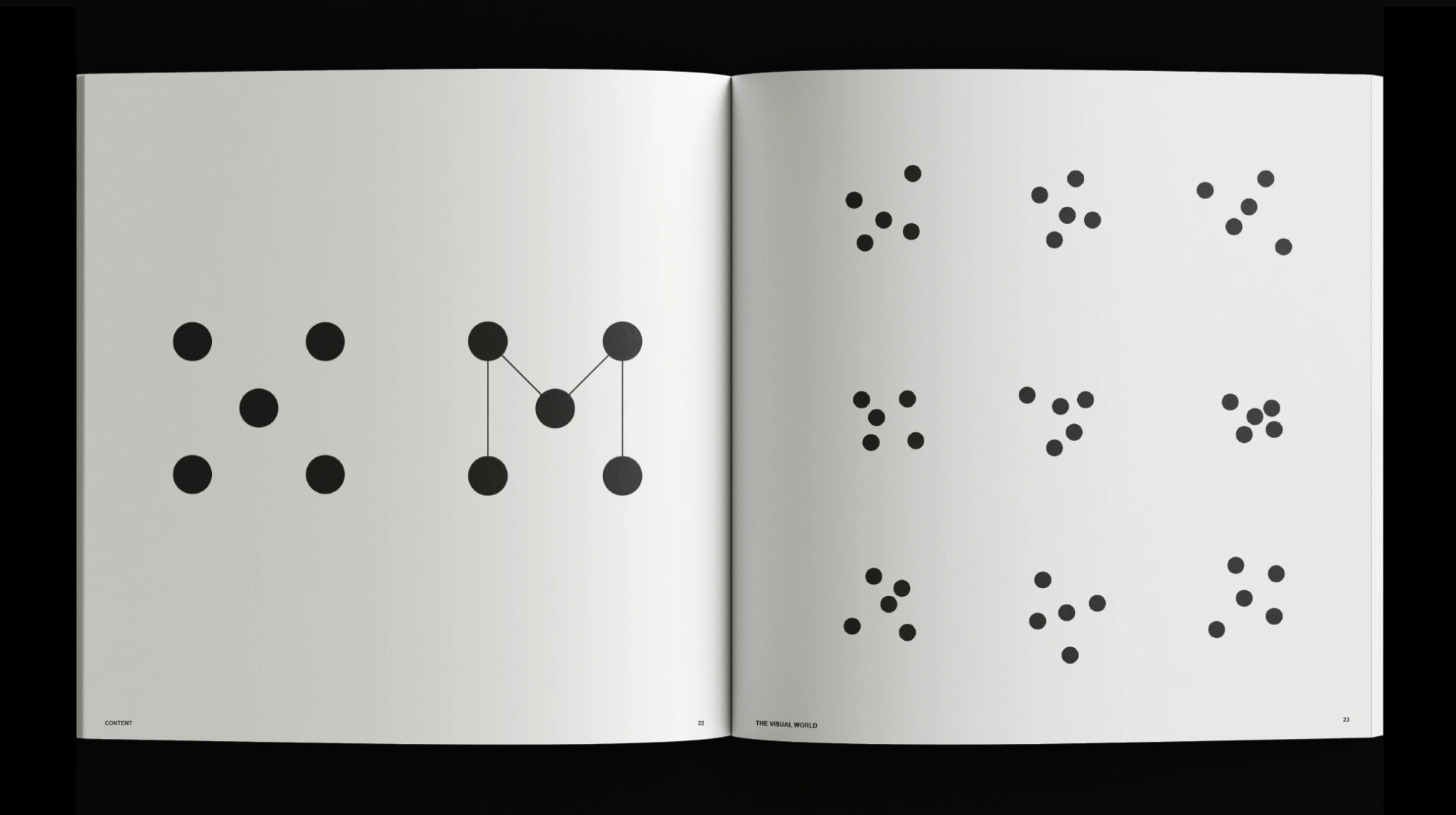 Open book showing five-point identity sketches and graphic variations