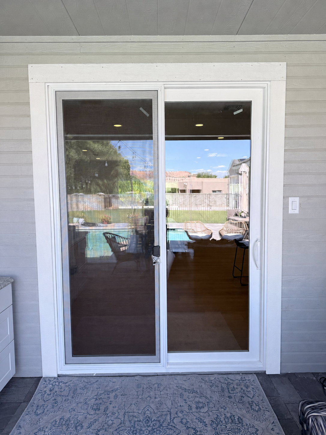 Finished exterior sliding glass door with painted white trim