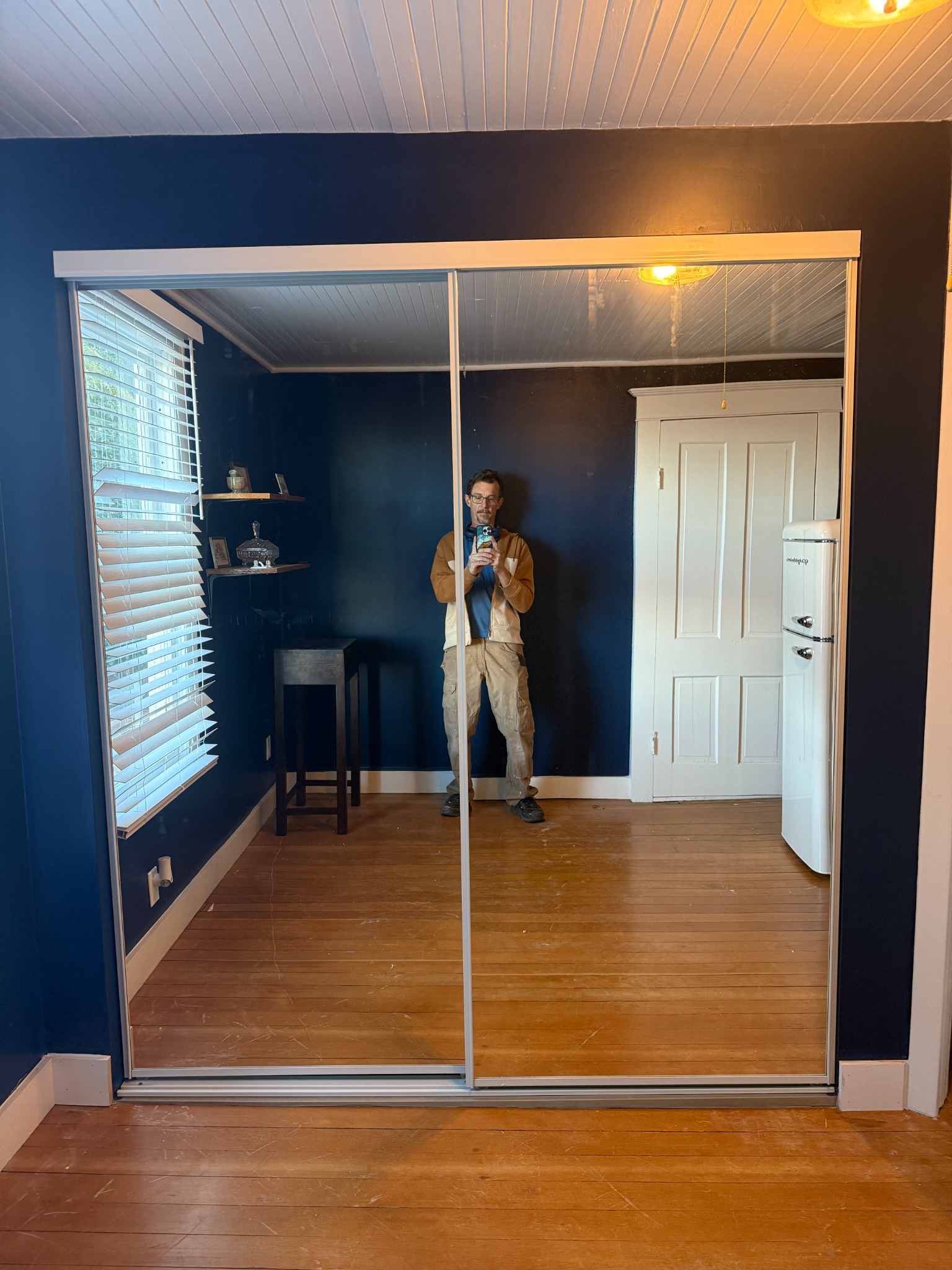 Finished expanded closet with mirrored sliding doors