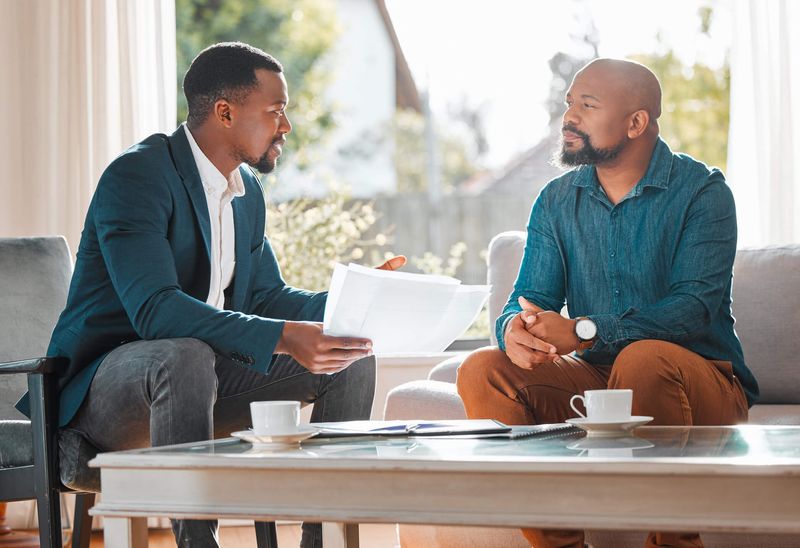 Two professionals in a one-on-one consultation over documents