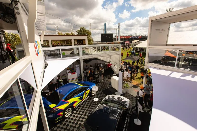 Cars and visitors inside the eBay and McLaren fan hub at the United States Grand Prix