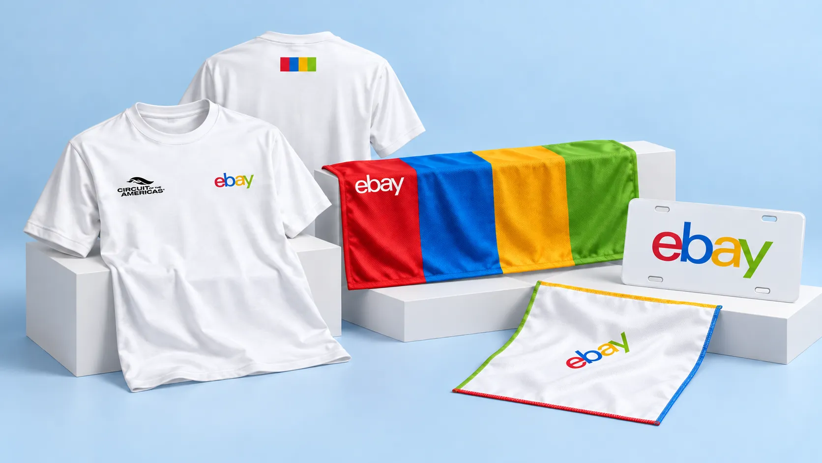 Studio visualization of eBay Motors custom tees, four-color cooling towel, pocket square, and vanity license plate